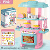 A pink mini pretend play kitchen set with cooking accessories and a storage box.