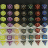 A collection of polyhedral dice in various colors and patterns arranged in rows on a white surface.