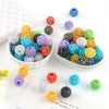 A collection of colorful rhinestone resin bayberry beads in various shades and sizes displayed on a white surface.