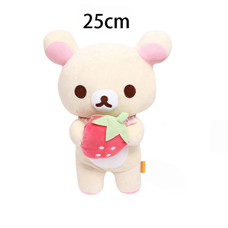 A soft, light beige Rilakkuma anime plush bear with pink accents and a strawberry accessory.