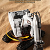 A white RC excavator toy with a rotating body is shown on sand, demonstrating omnidirectional rotation.
