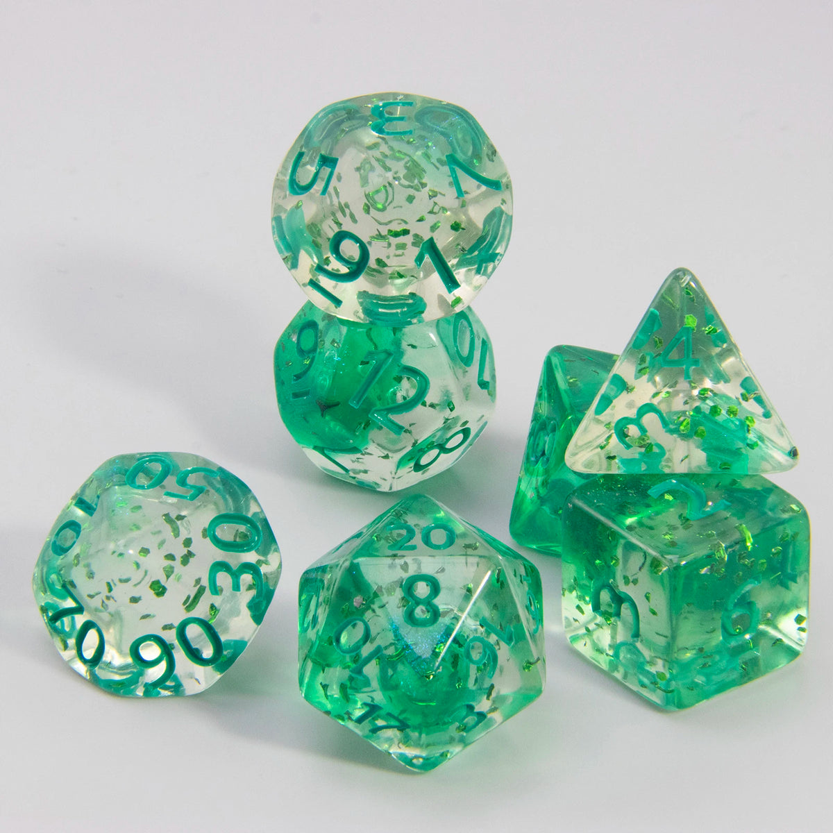 A set of green glitter polyhedral dice including a D4, D6, D8, D10, D12, and D20.