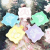A collection of pink, blue, green, and yellow plastic organizer trays with lids for diamond painting supplies.