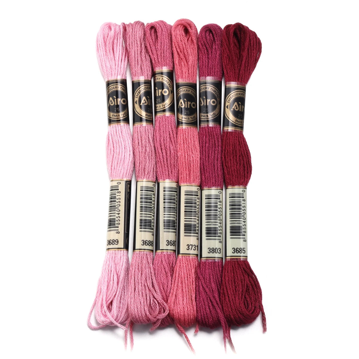 A set of six skeins of vibrant pink and magenta embroidery thread for cross stitch and DIY crafts.