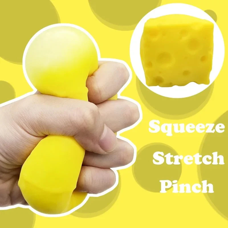A hand squeezes a yellow cheese-shaped fidget toy, demonstrating a stretch and pinch action.