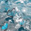 A close-up of blue butterfly paint by numbers on canvas floating in water.