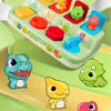 A green pop-up animal toy set featuring various colorful plastic animals for cause and effect learning.