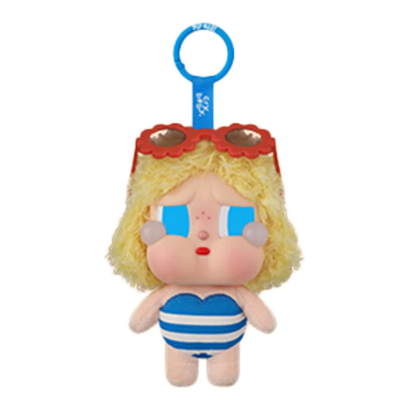 A vinyl figure of a girl with blonde hair wearing a red and orange visor and a blue and white striped outfit.