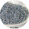 A pile of iridescent, spherical metallic glass beads used for jewelry and crafting.