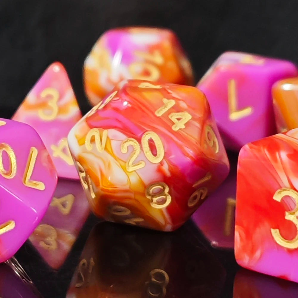 A close-up of a set of seven polyhedral dice featuring swirling pink, orange, and red tones with gold numbering.