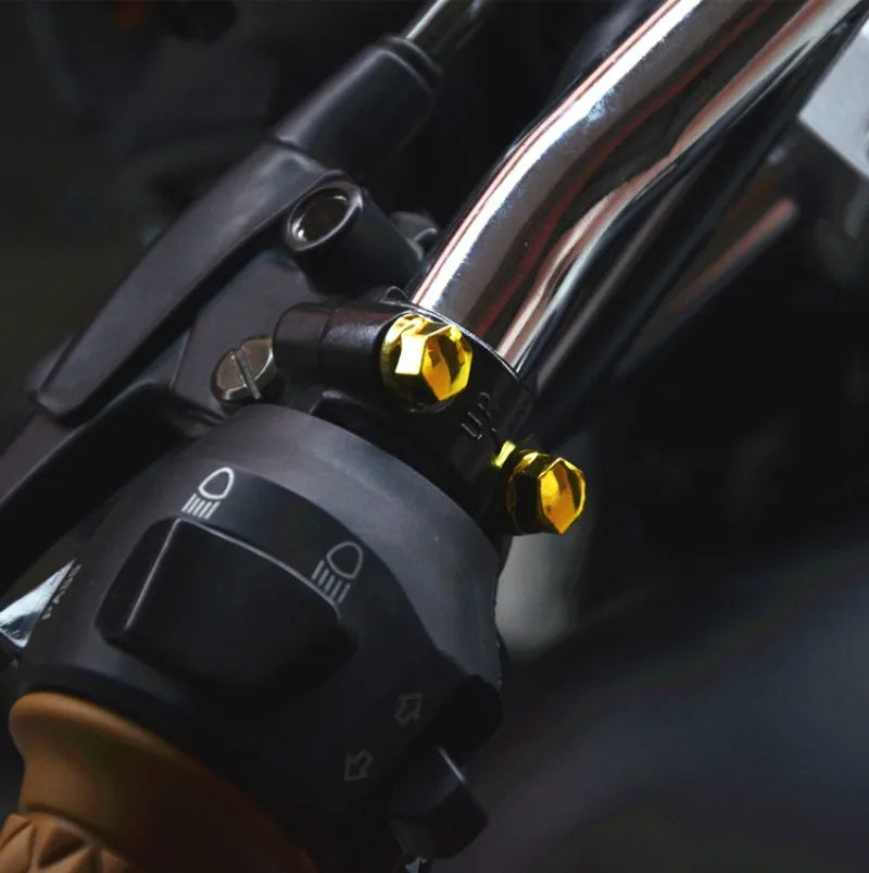Close-up of a motorcycle screw cover decorative cap set installed on a handlebar fitting.