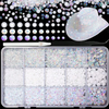 A collection of flatback resin rhinestones and glitter in various colors and sizes displayed in a clear plastic tray.