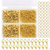 A clear plastic box filled with gold-colored lobster clasps and open jump rings for jewelry making