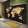 A large canvas print of the world map in gold glitter on a black background displayed in a modern room.