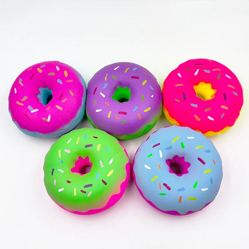 A collection of six brightly colored, squishy donut-shaped stress relief sensory fidget toys for kids.