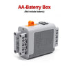 A gray AA battery box with an orange cap, designed for a technical power functions motor set.