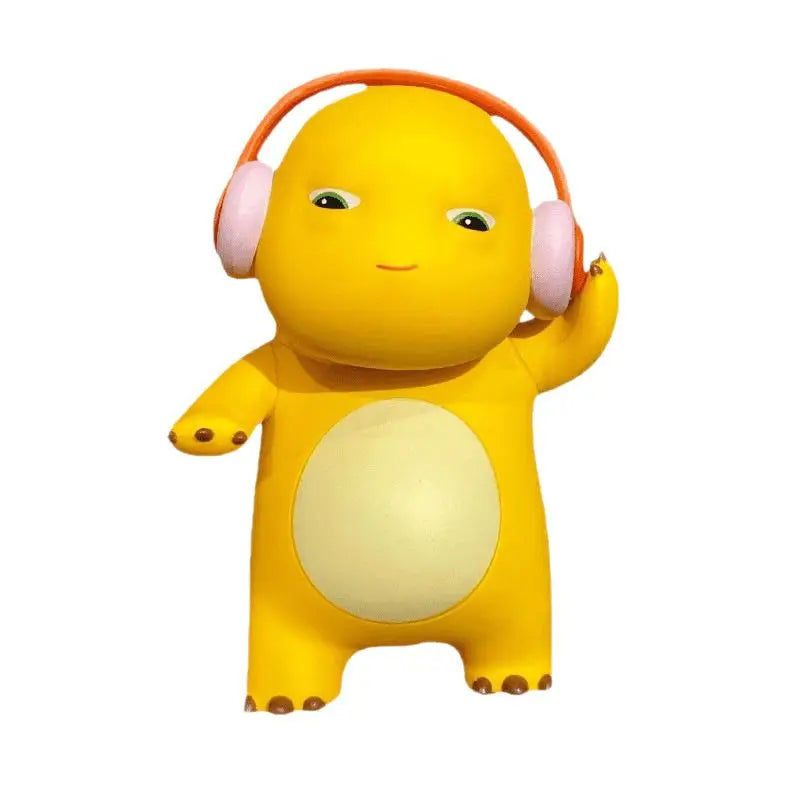A yellow, round figurine with pink headphones and a large light-colored belly.