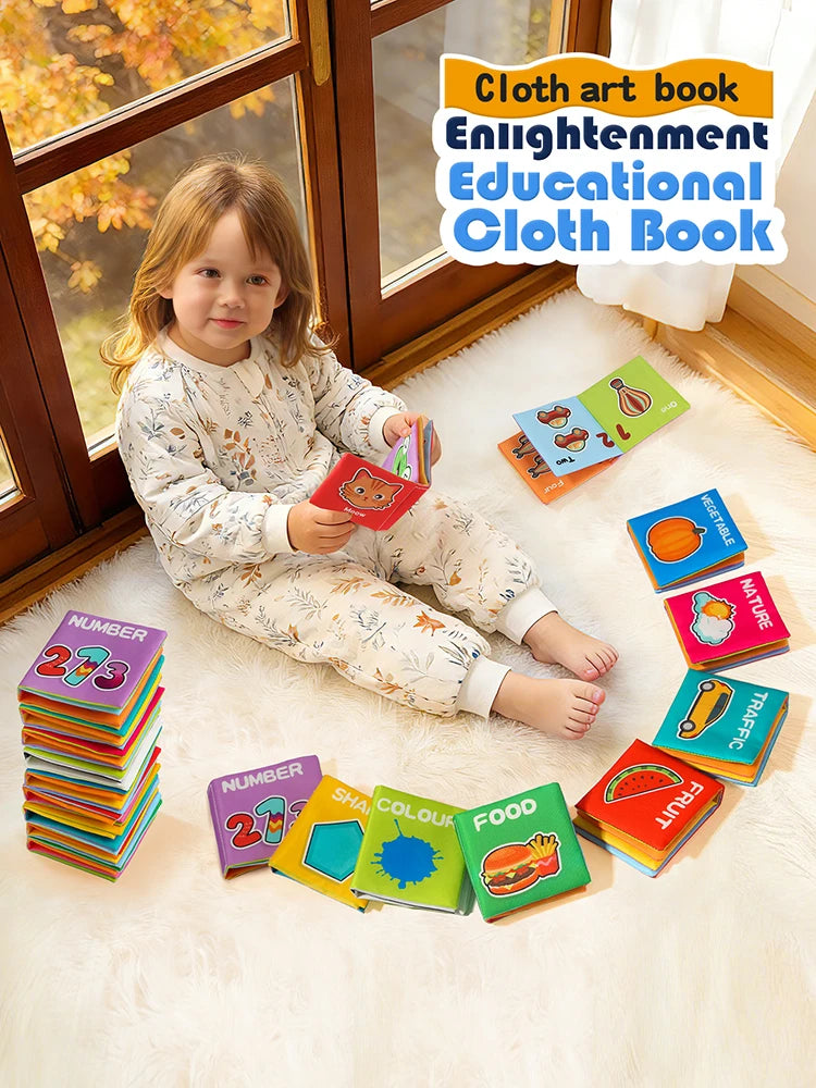 A set of nine colorful cloth books featuring educational themes like number, shape, and fruit, displayed on a white rug.