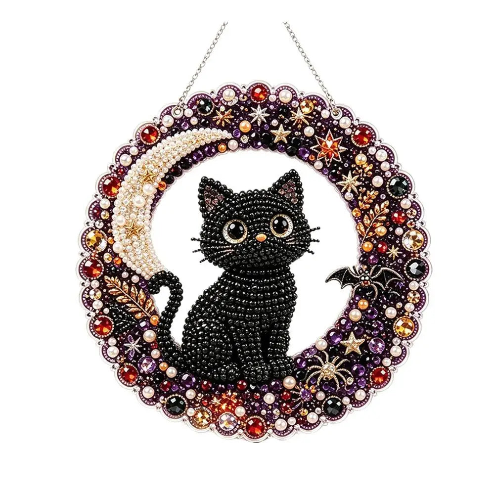 A hanging ornament kit featuring a black cat silhouette surrounded by sparkling jewels and a crescent moon.