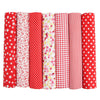 A pack of seven red fabric squares with various patterns including polka dots, stripes, and floral prints for quilting