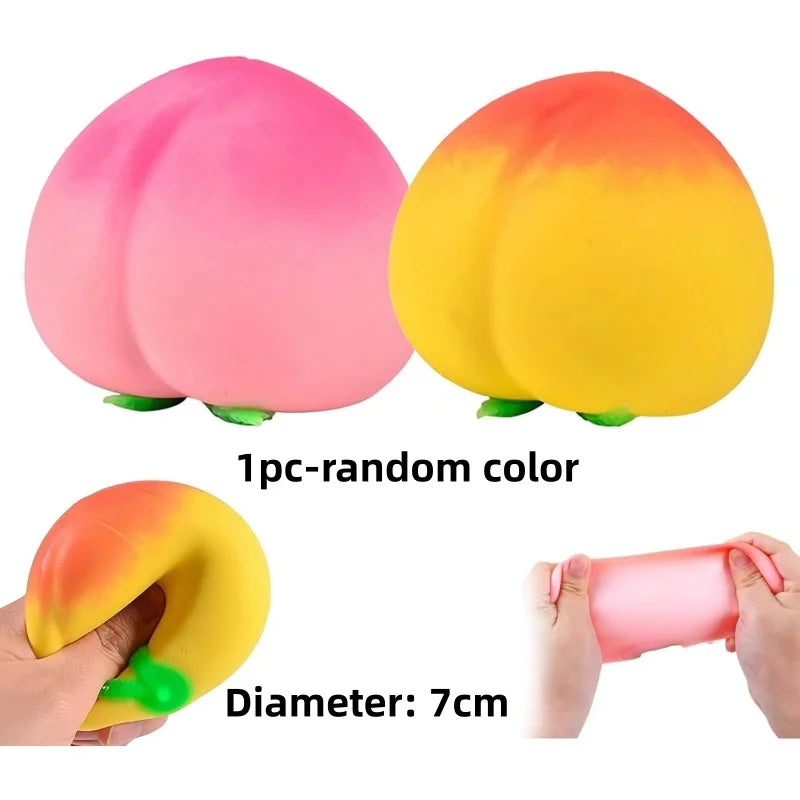Two pink and yellow fruit squishy stress relief fidget toys shown with a hand for scale, 1 piece random color, diameter 7cm