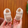 Pair of beige soft sole sandals shaped like bears for a baby's first steps
