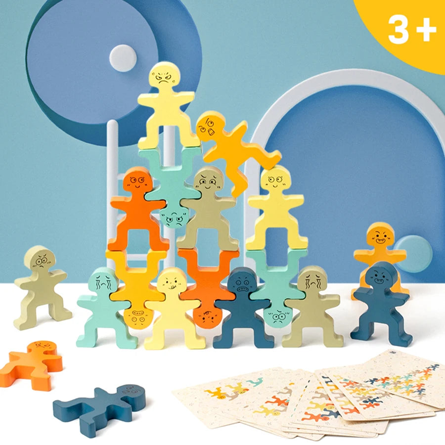 A collection of wooden balance stacking blocks in various colors and shapes arranged in a pyramid on a white surface.