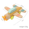 A wooden train toy featuring an orange body and light green accents, with attached wooden wings and yellow beads.