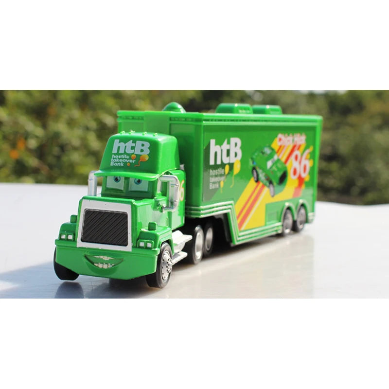 A green Pixar Cars die-cast toy hauler truck with a green trailer and branding.