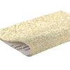 Gold sparkling rhinestone adhesive tape roll showing the textured surface and edge.