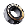 A black magnetic fidget ring with gold accents and a textured surface is shown in a top-down view.