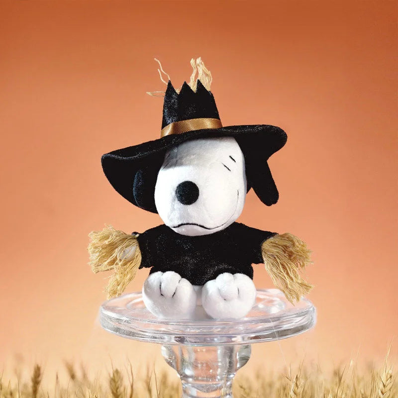 A collectible figure of Snoopy Mischief Party Series, featuring a black hat and fluffy yellow accents, displayed on a clear s