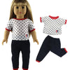A doll wearing a casual outfit set consisting of a white top with black polka dots and navy pants.