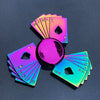 A fan of rainbow metal fidget spinners showing various card suits and numbers.