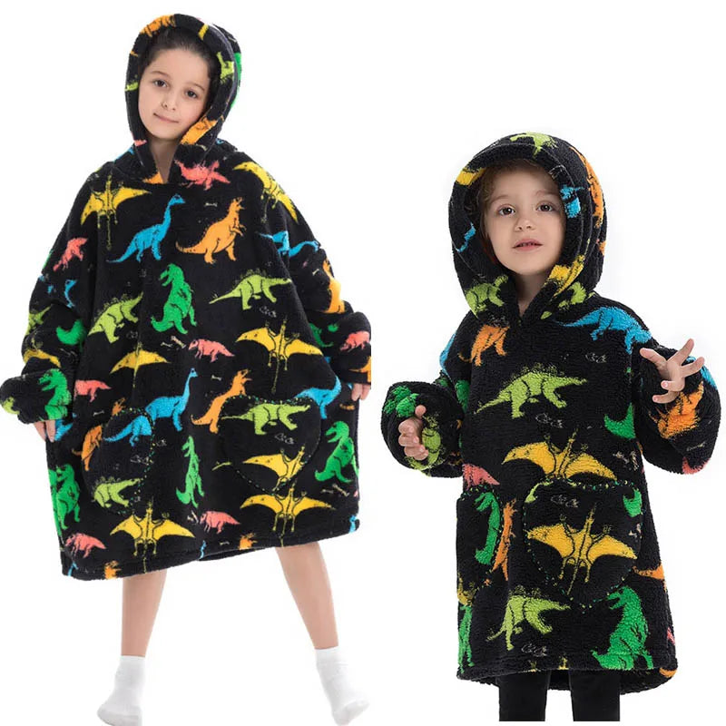 A young girl models a black flannel hoodie sweater with colorful dinosaur print.