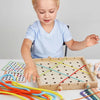 A young child is interacting with a wooden lacing board toy featuring colorful ropes and threads for practice.