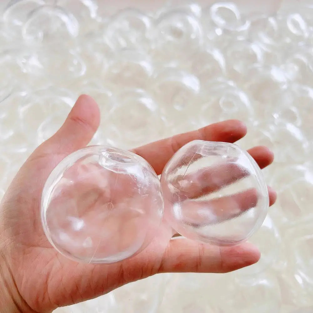 A hand holds a clear, translucent squishy stress ball cover with a refillable shell against a background of similar items.