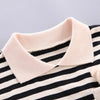 A close-up of a black and beige striped kids' summer outfit set featuring a collared top.