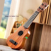 A wooden toy guitar is displayed next to a wooden box, showing its size and detail.