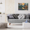 A gray sofa in a living room with a painting of a mountain cabin lake view above it.