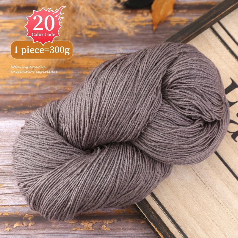 A ball of gray premium alpaca blend yarn used for knitting or weaving, displayed on a wooden surface.