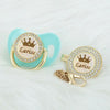 Personalized rose gold crown pacifier and clip set with a light blue silicone component