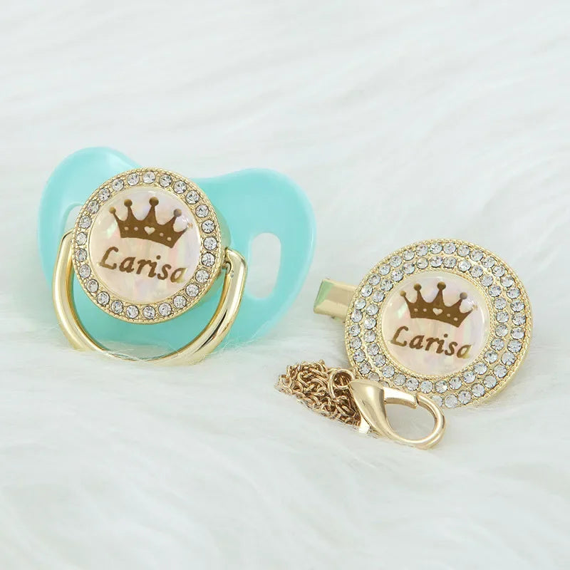 Personalized rose gold crown pacifier and clip set with a light blue silicone component