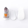 A pair of breathable anti-slip baby first walker shoes shown with the shoe and sole separated.