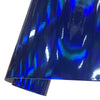 A close-up of holographic chrome blue vinyl wrap film showing iridescent light reflections.