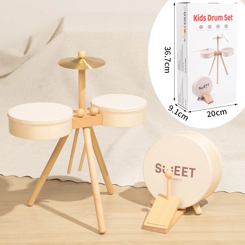 A wooden kids drum set with a mallet and various drums shown on a light background.