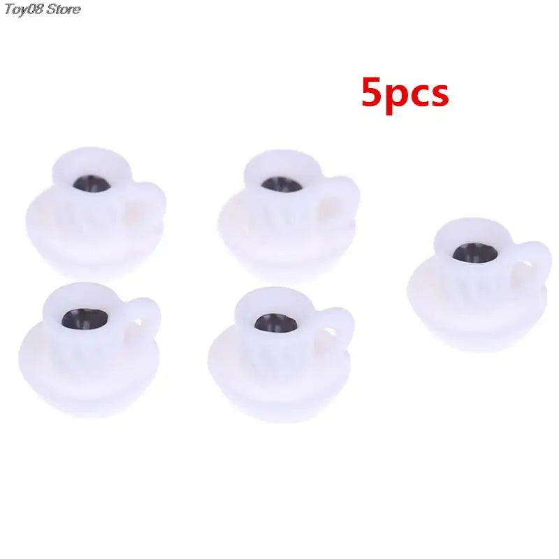 A set of five white mini resin coffee cups designed for dollhouse kitchens.