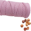 A spool of pink natural cotton macrame rope for crafts and decor.