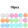 A collection of reusable quick-fill water balloons in various pastel colors including white, pink, blue, and orange.