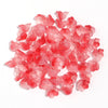 A pile of 50 glass beads shaped like cherry blossoms in shades of pink and red for jewelry making